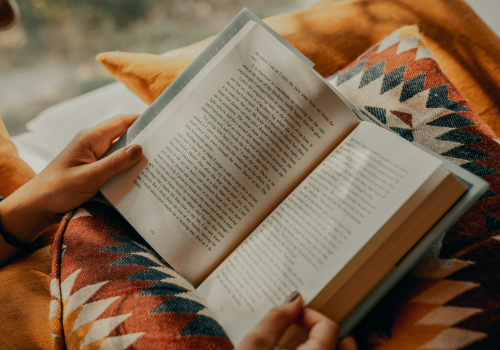 lire un livre ouvert sur un plaid